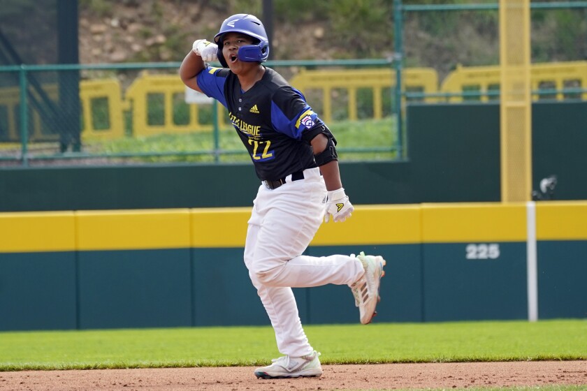Torrance's Grant Hays flexes as rounds the bases on his three-run home run.