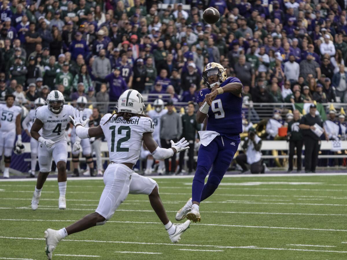 Washington's Michael Penix Jr. throws a touchdown pass past Michigan State's Chester Kimbrough on Sept. 17, 2022.