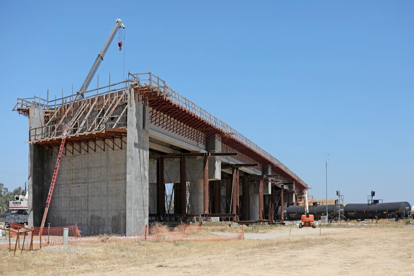 MADERA, CA - AUGUST 05: A 700 foot bullet train bridge across Road 27, between Road 27 and Club Dr., and the BNSF main line in Madera County had a serious problem with corroded tension strands that broke in December 2019, on Wednesday, Aug. 5, 2020 in Madera, CA. The California High-Speed Rail Authority is making repairs, though the incident points to seriously underlying problems in the project's management. After the strands (steel cables) broke, construction teams shored up the bridge with falsework. (Gary Coronado / Los Angeles Times)