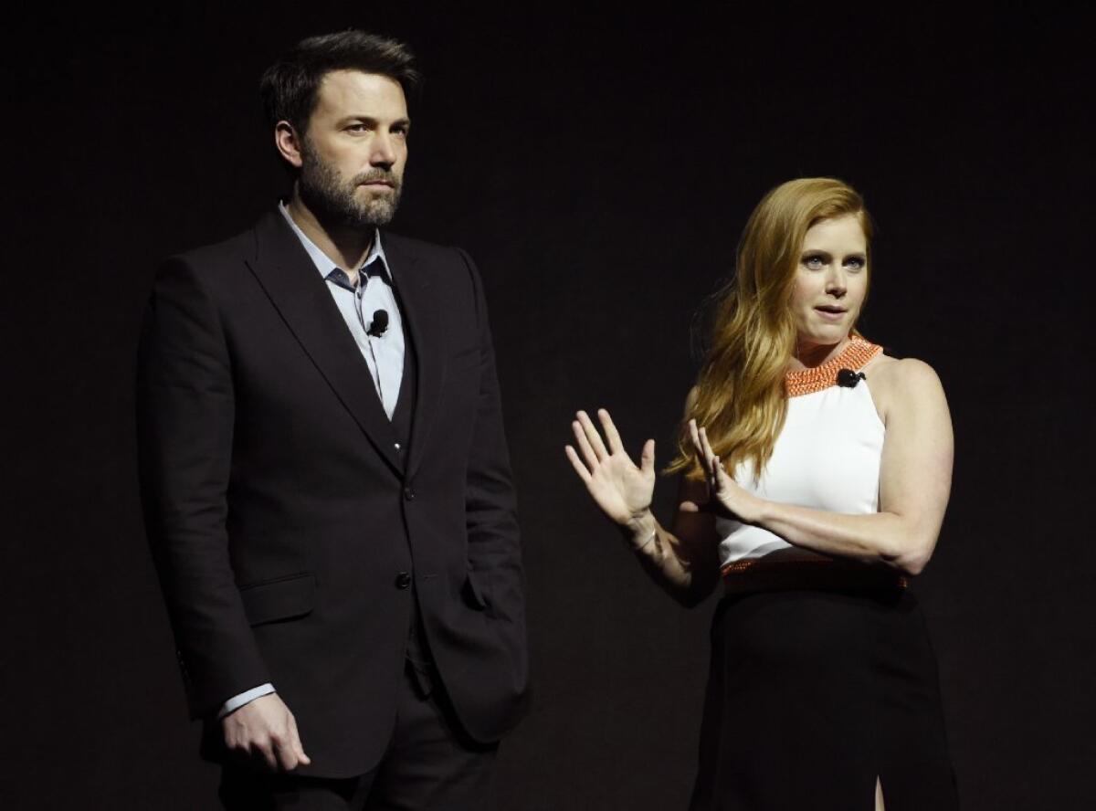Stars Ben Affleck and Amy Adams address the audience during the Warner Bros. presentation at CinemaCon 2016, the annual theater owners conference.