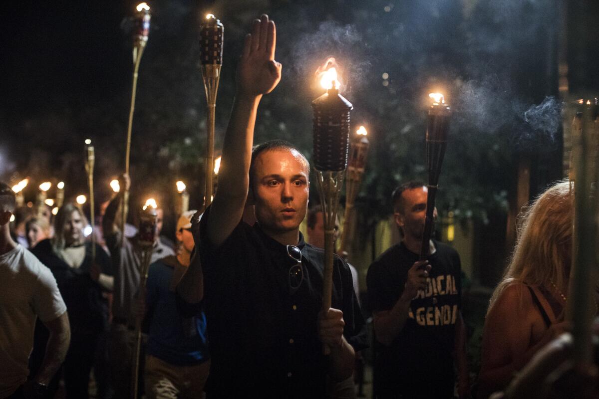 Torch-bearing white nationalists rally near the University of Virginia campus in Charlottesville, Aug. 11, 2017. 