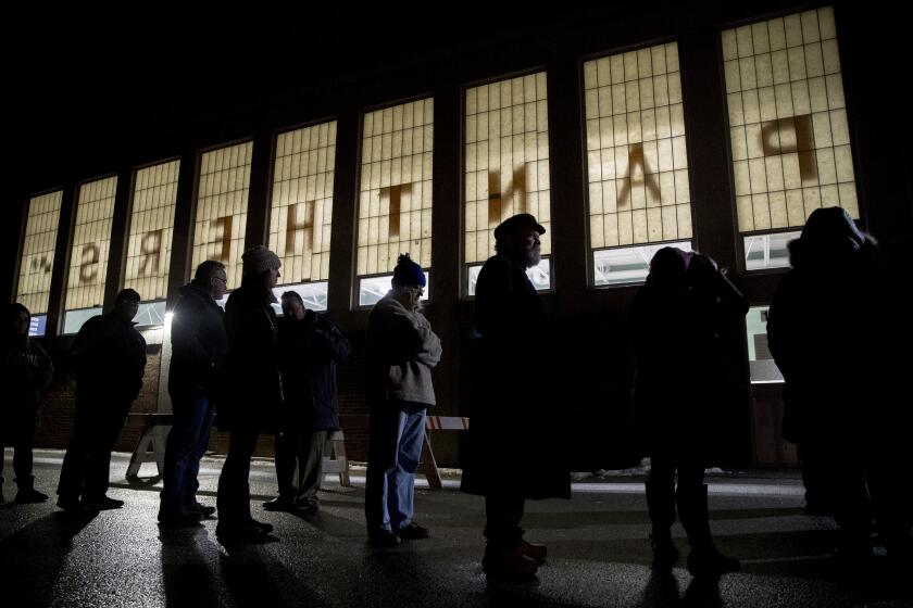 New Hampshire primary voters wait for their voting precinct to open outside Parker-Varney Elementary School, Tuesday, Feb. 11, 2020, in Manchester, N.H. (AP Photo/Andrew Harnik)
