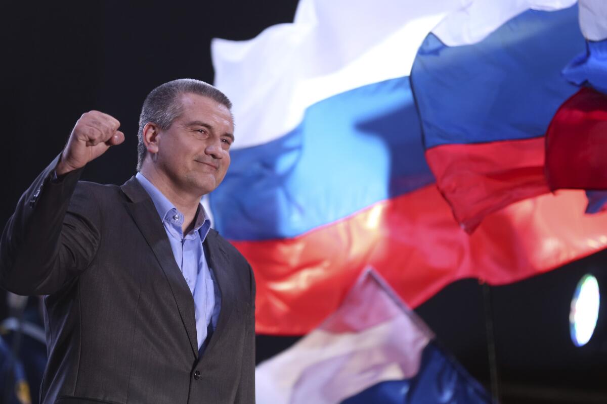 Crimea's Russia-backed leader Sergei Aksyonov gestures as people celebrate in Lenin Square in downtown Simferopol on Sunday night after a referendum backed annexation by Russia.