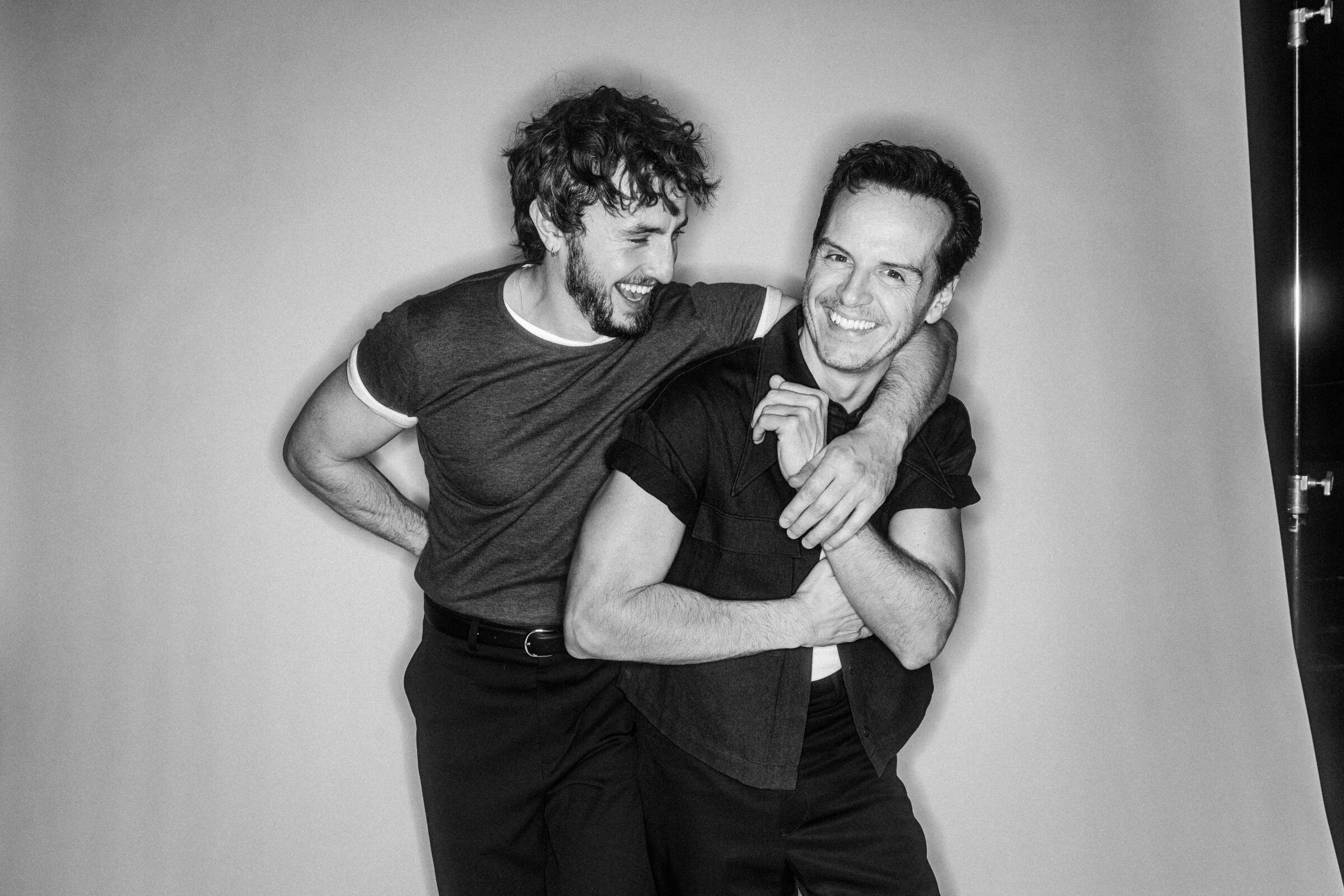 Andrew Scott and Paul Mescal laugh while posing for a portrait together.