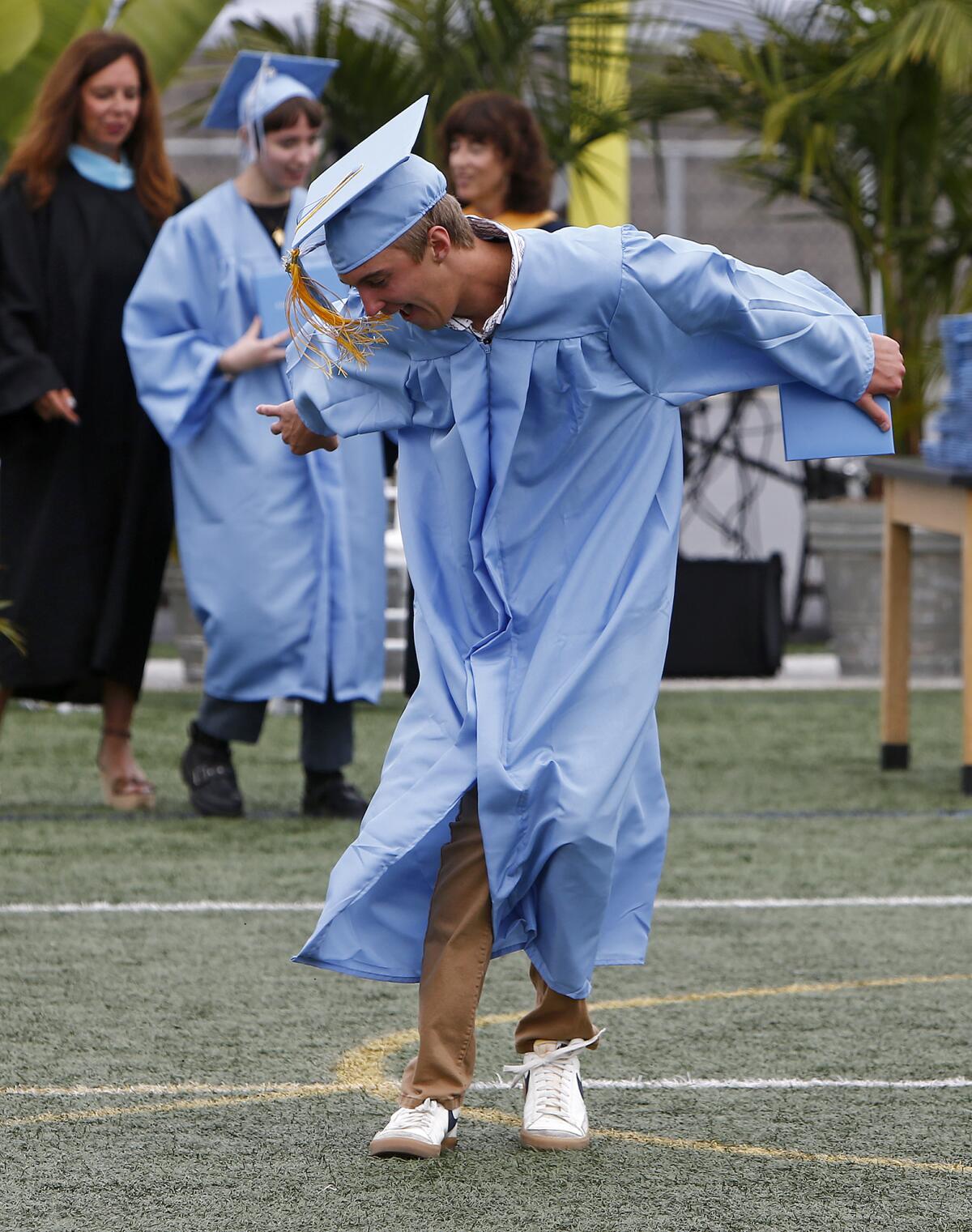 Ronan Carter does the "Griddy" dance after receiving his diploma.