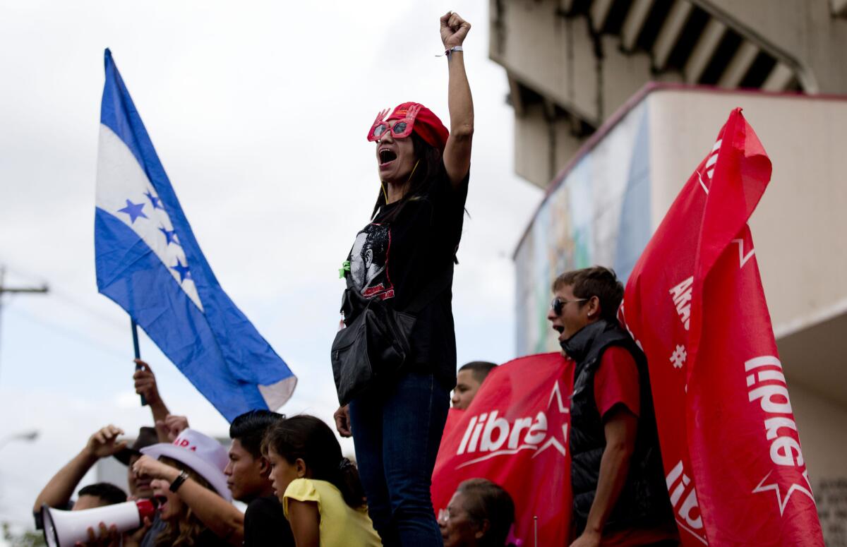 A supporter of Free Party presidential candidate Xiomara Castro shouts slogans during a protest against election results in Tegucigalpa, Honduras.