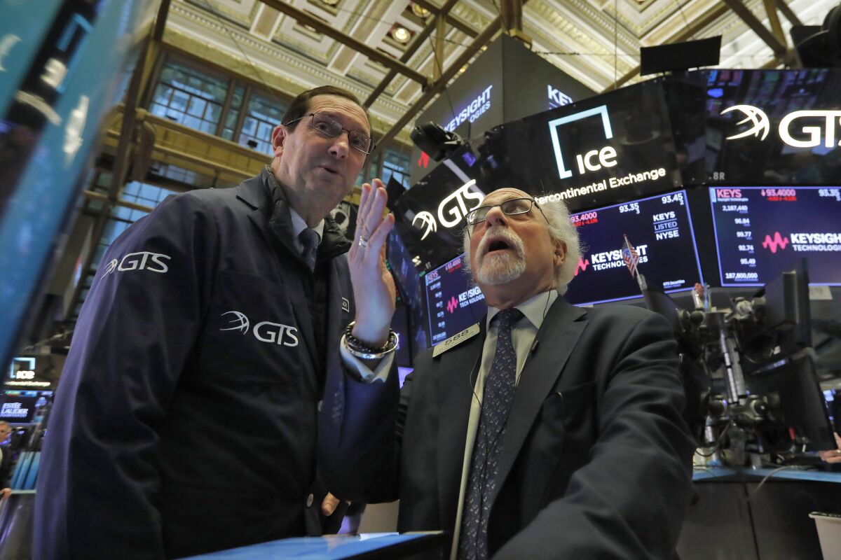 Traders work on the floor of the New York Stock Exchange earlier in the week. T