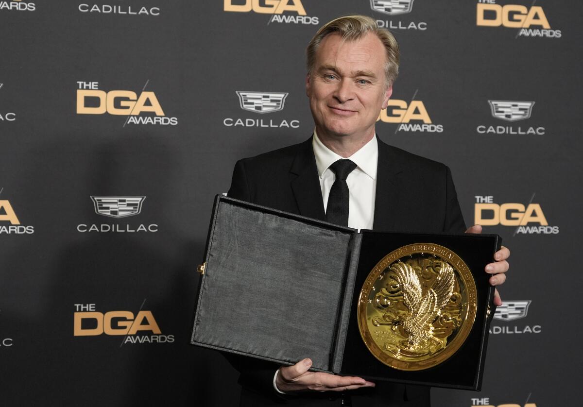 Christopher Nolan holds his DGA Award 