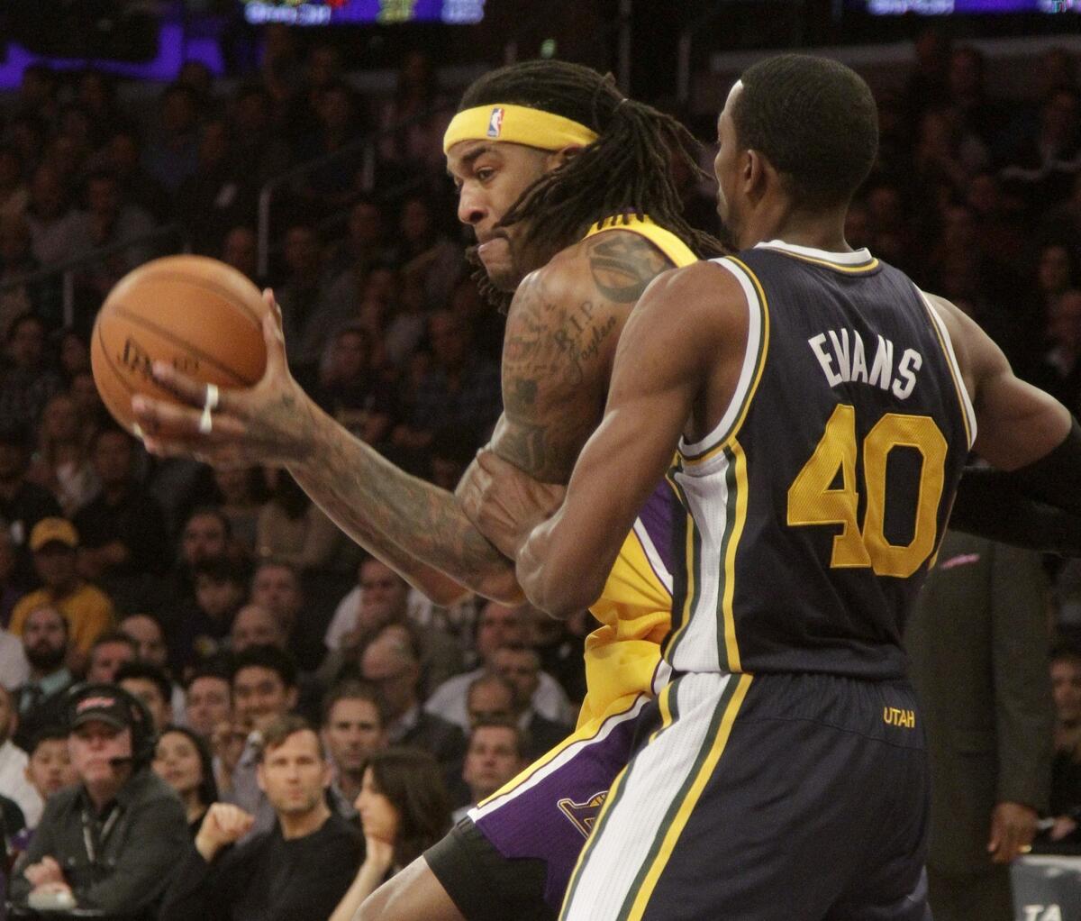 Jordan Hill works against Utah's Jeremy Evans during the Lakers' matchup Tuesday with the Jazz at Staples Center.