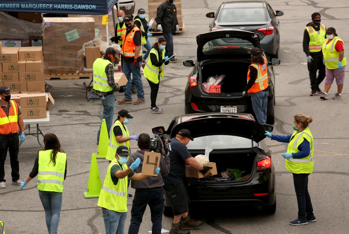 Cars line up at a food distribution site in Los Angeles.