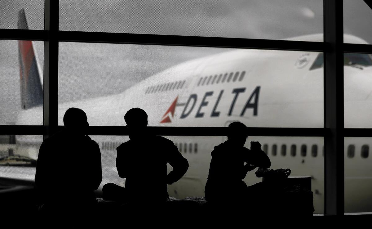 The computing error on Delta Air Lines' website that resulted in ultra-cheap fares was corrected within a couple of hours, the airline said. Above, travelers wait for a Delta flight in Detroit.