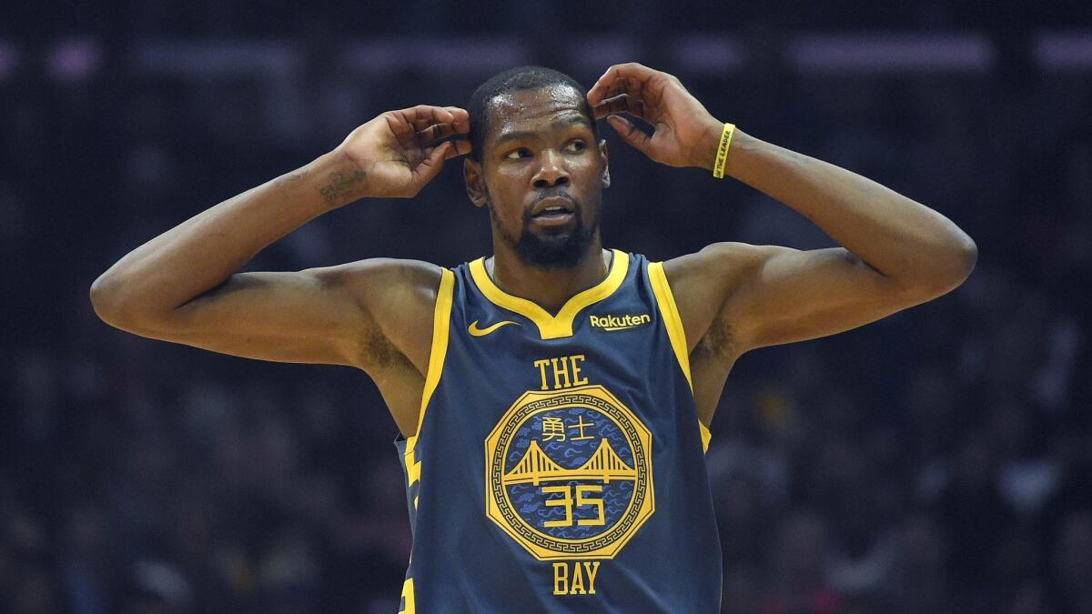 Golden State Warriors forward Kevin Durant gestures during a break in the game against the Clippers.