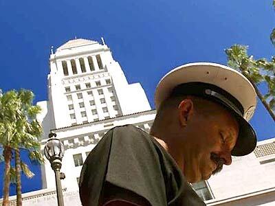Los Angeles City Fire Department Captain John Holtby observes a moment of silence at City Hall.