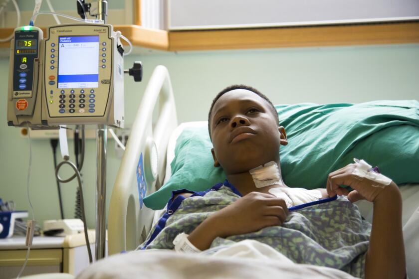 Markell Williams, 11, spends the night at a Pensacola, Fla., hospital after having surgery to insert an implant intended to ease his seizures, which increased after a chemical leak in his hometown of Eight Mile, Ala.