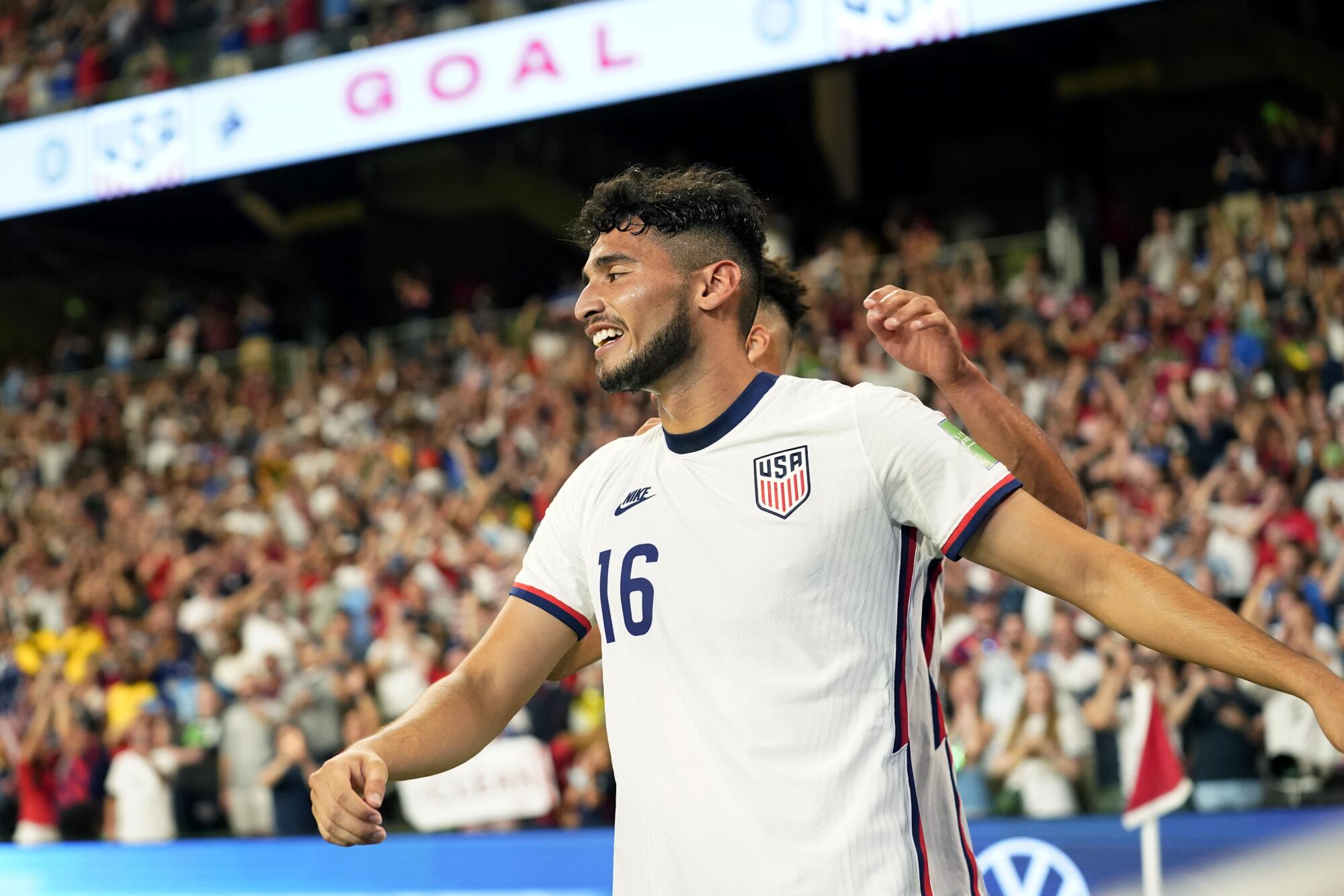 The United States' Ricardo Pepi (16) celebrates with teammates after scoring his second goal against Jamaica.