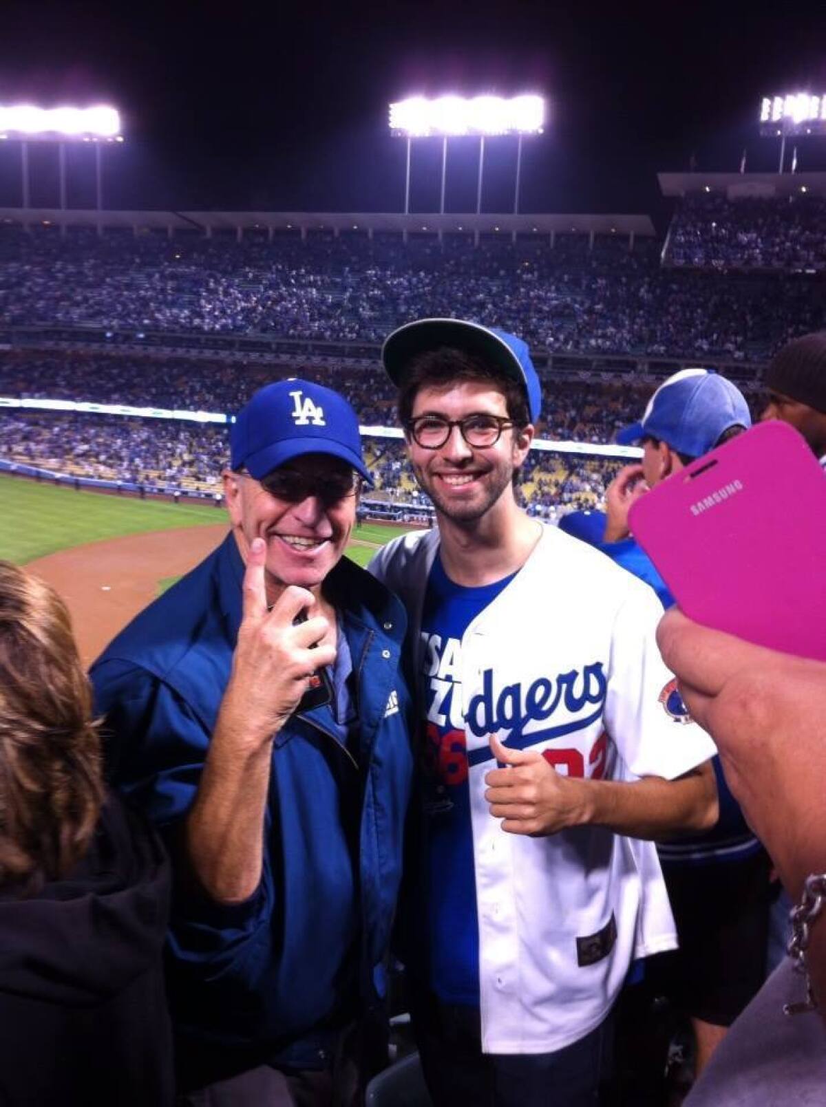Julian Rubel smiles with his father at a Dodgers game in 2013.