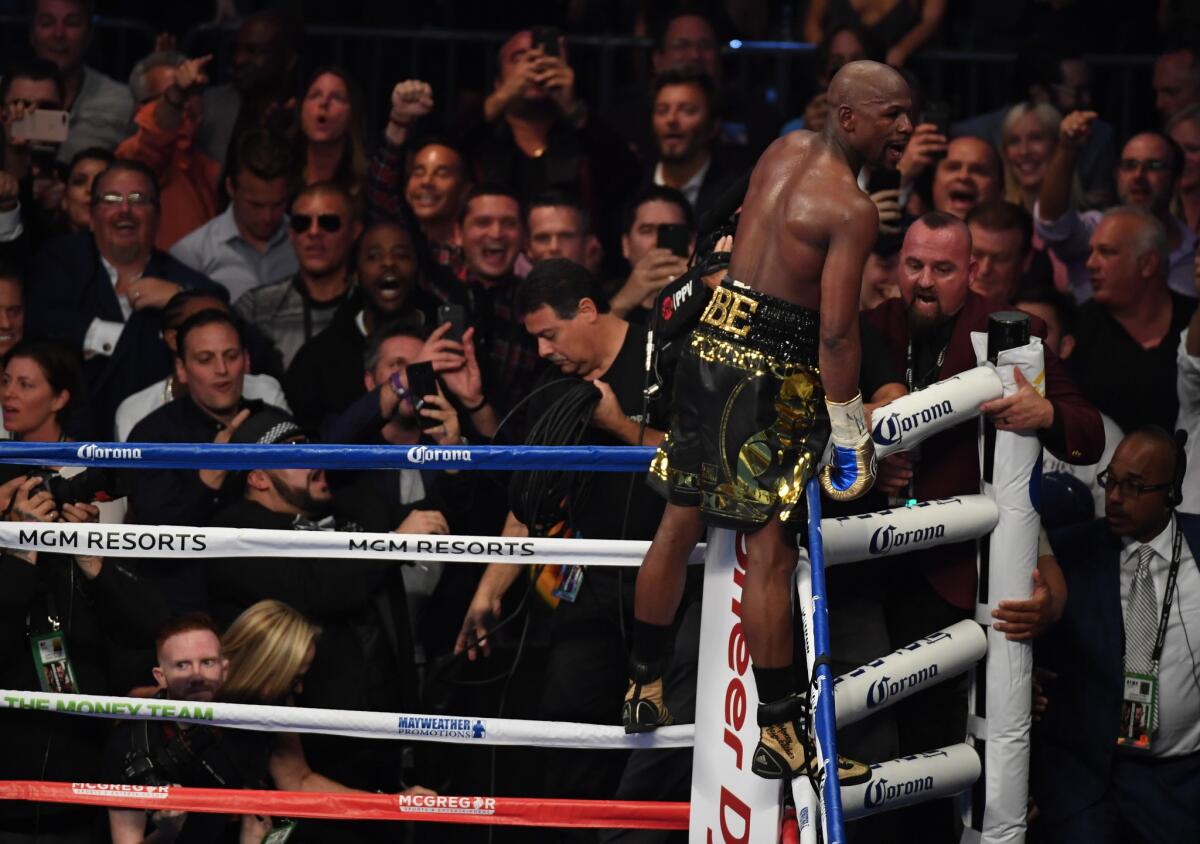 Floyd Mayweather Jr. celebrates his victory over Conor McGregor after their super-welterweight fight.