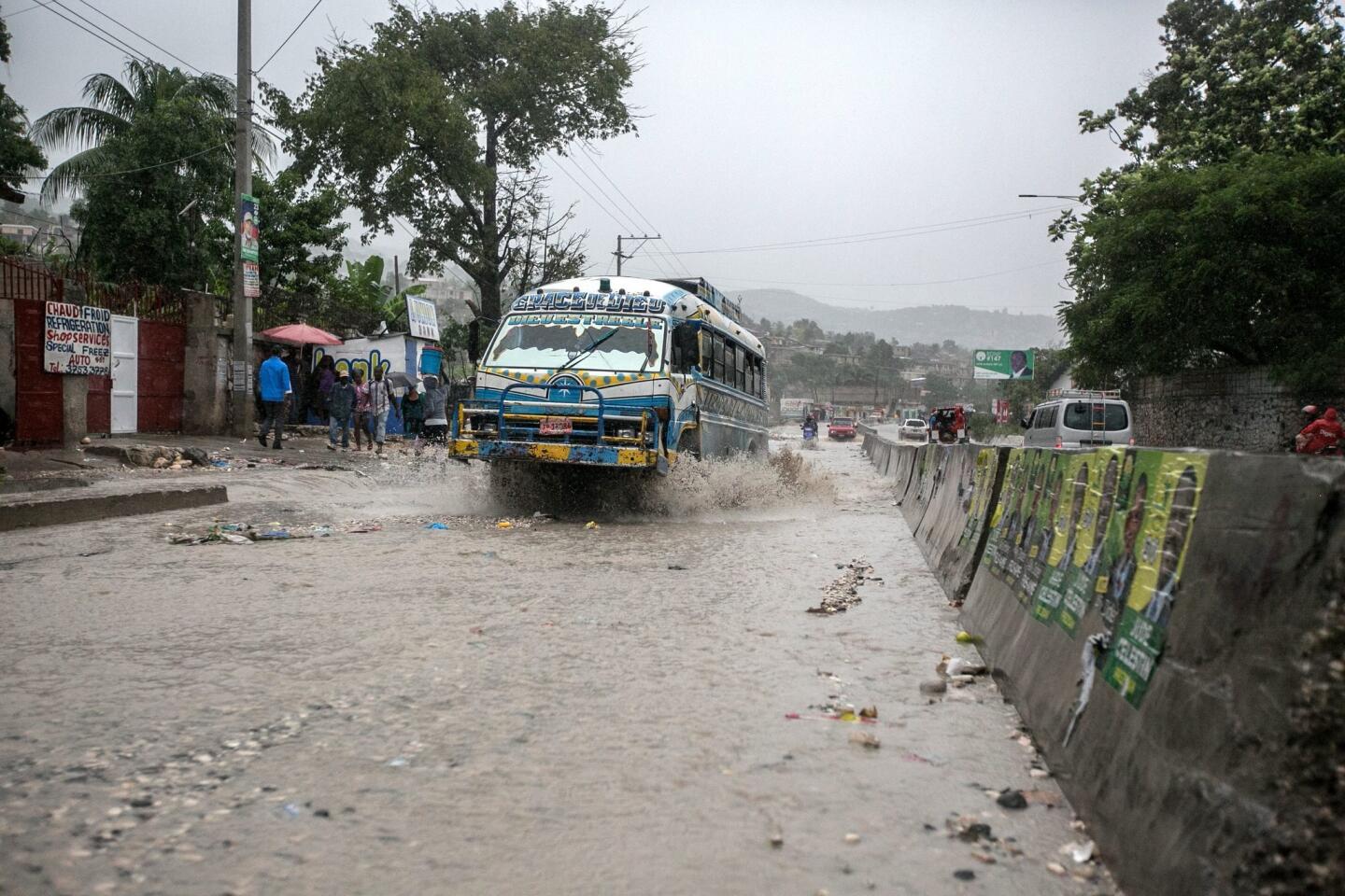 A bus drives through a flooded street in Port-au-Prince, Haiti, on Oct. 4, 2016.