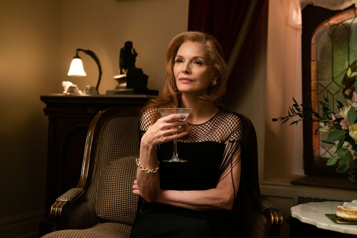 Michelle Pfeiffer holds a martini.