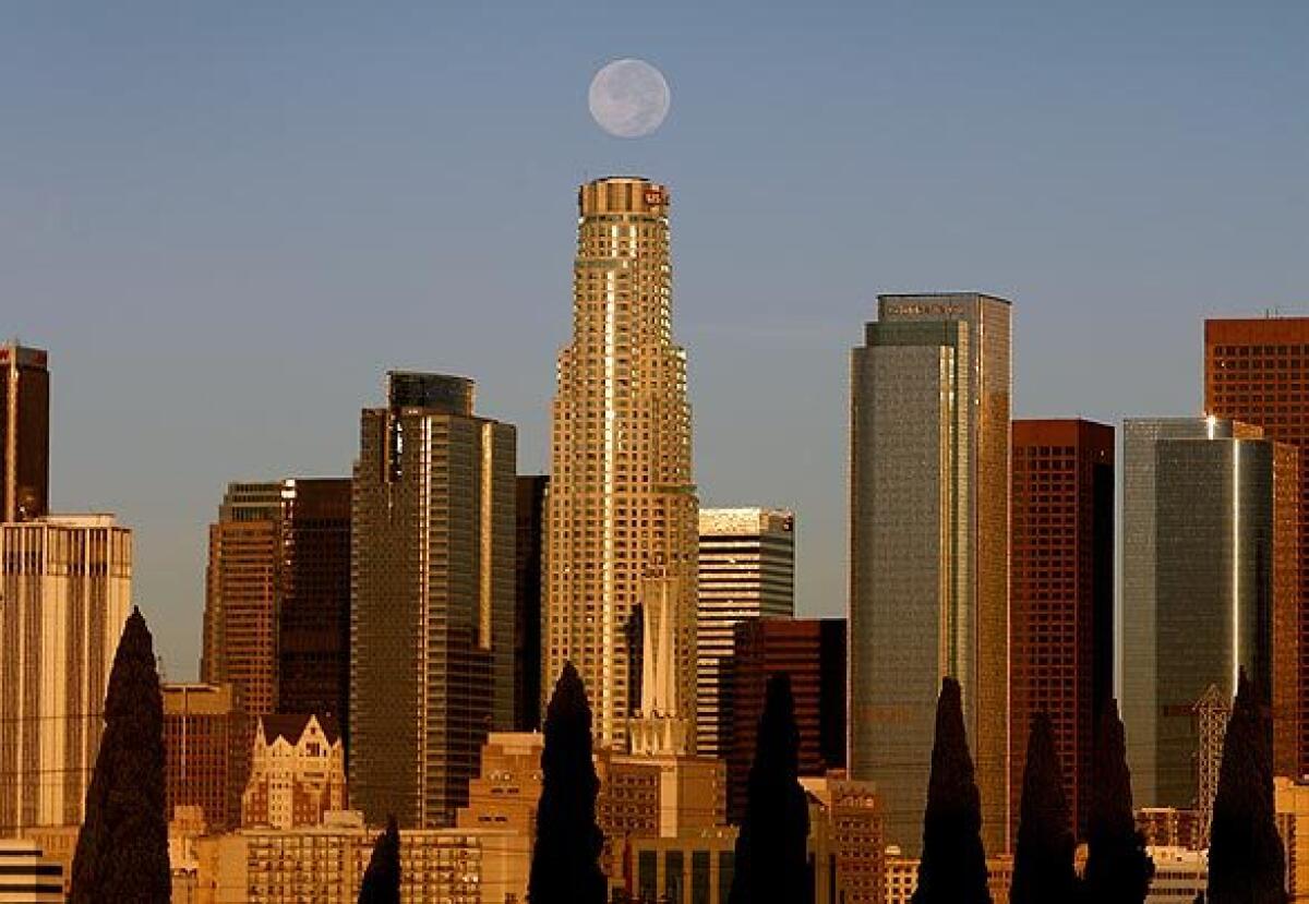 The downtown L.A. skyline on a 2008 day with a full moon directly above the U.S. Bank Tower.