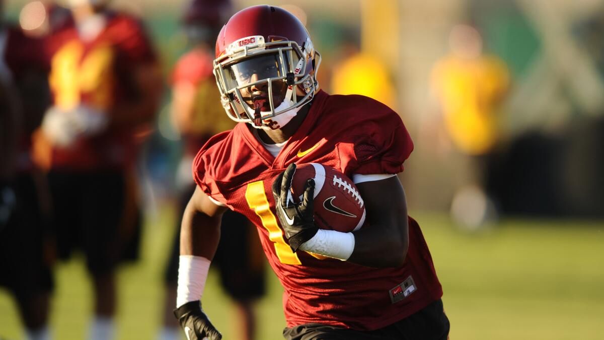 USC wide receiver Ajene Harris runs with the ball during a spring practice session in April.
