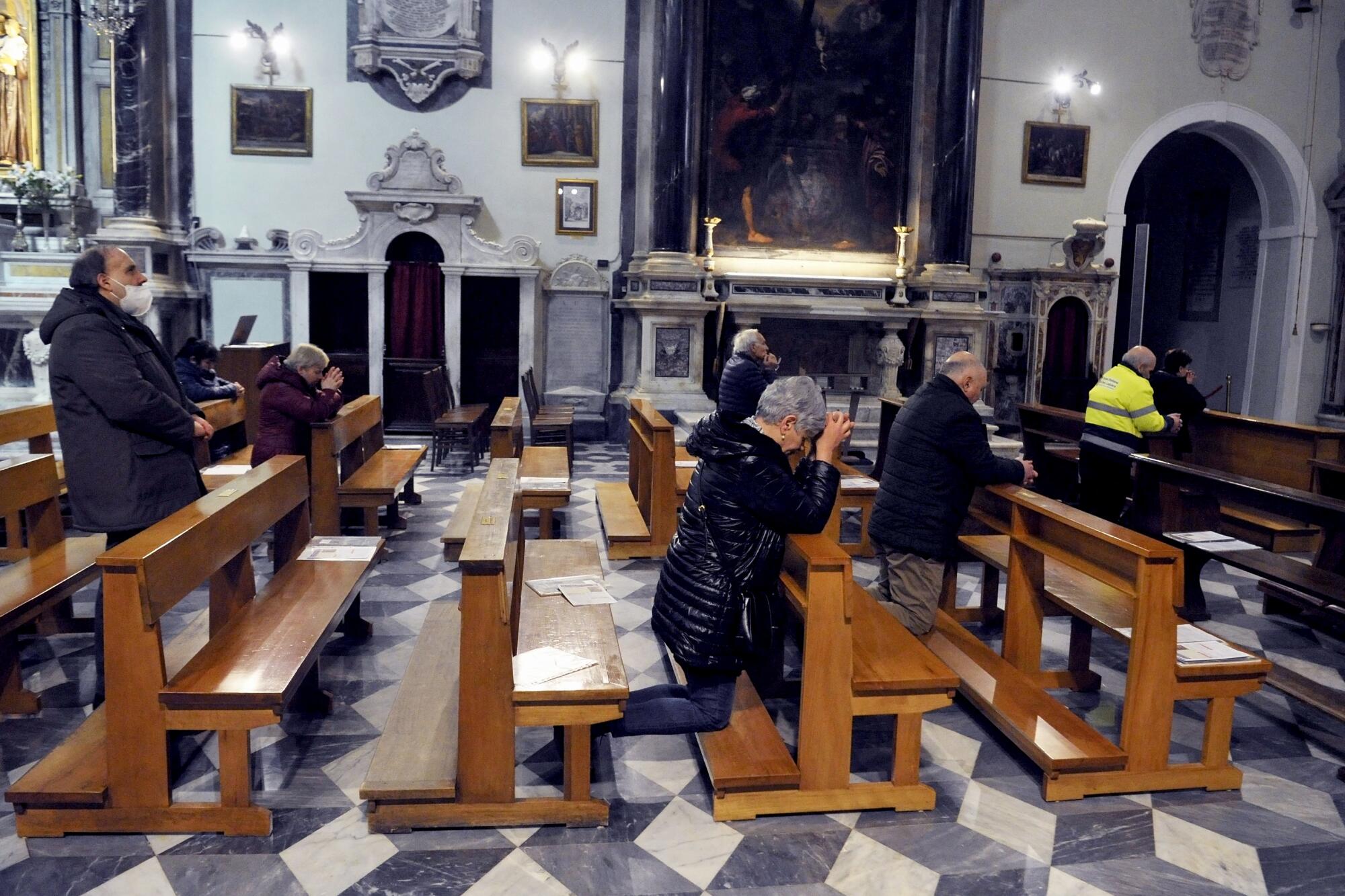 People observe social distancing during Sunday Mass in the ancient Church of the Madonna in Livorno, Italy.