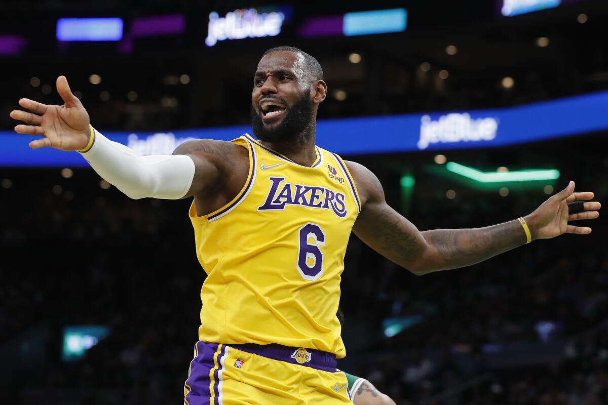 Lakers forward LeBron James spreads his arms as he questions why there was no foul call.