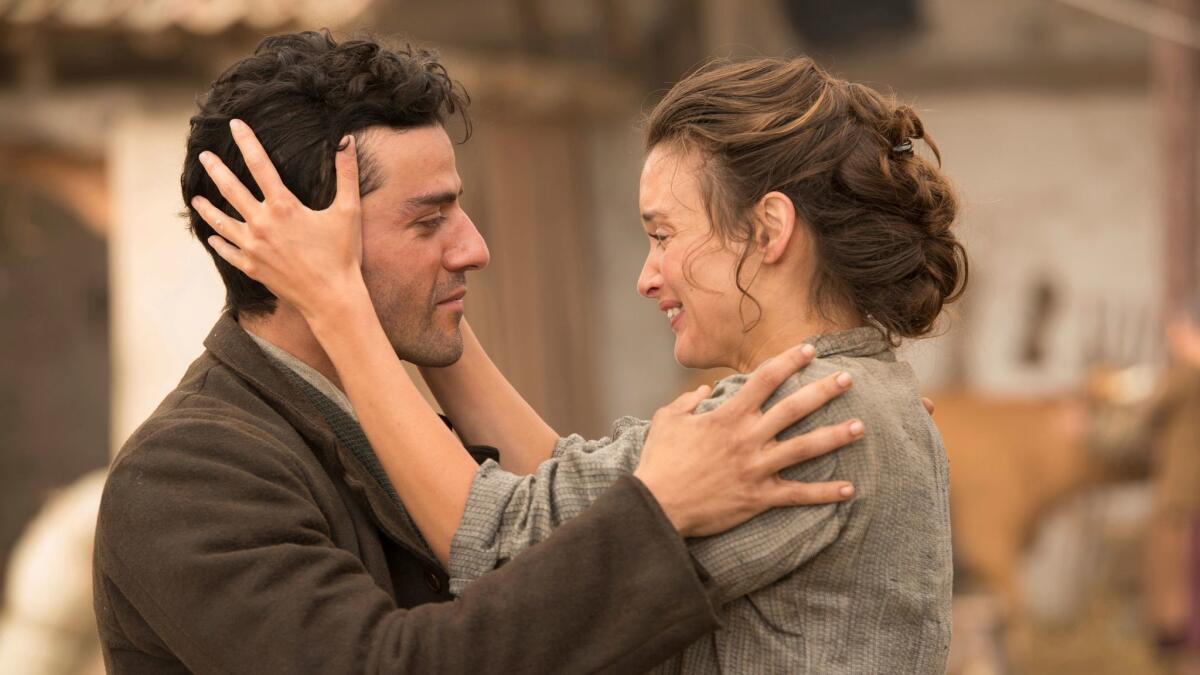 Oscar Isaac, left, and Charlotte Le Bon in a scene from "The Promise."