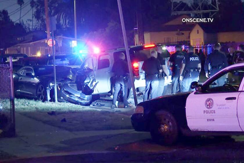 A man suspected of shooting at police officers in South Los Angeles is in custody today after a brief chase that ended with his crashing an SUV into several cars.