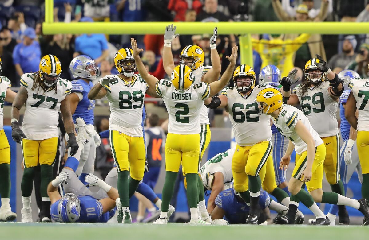 Mason Crosby celebrates after kicking a game-winning field goal in the Green Bay Packers' victory over the Detroit Lions.