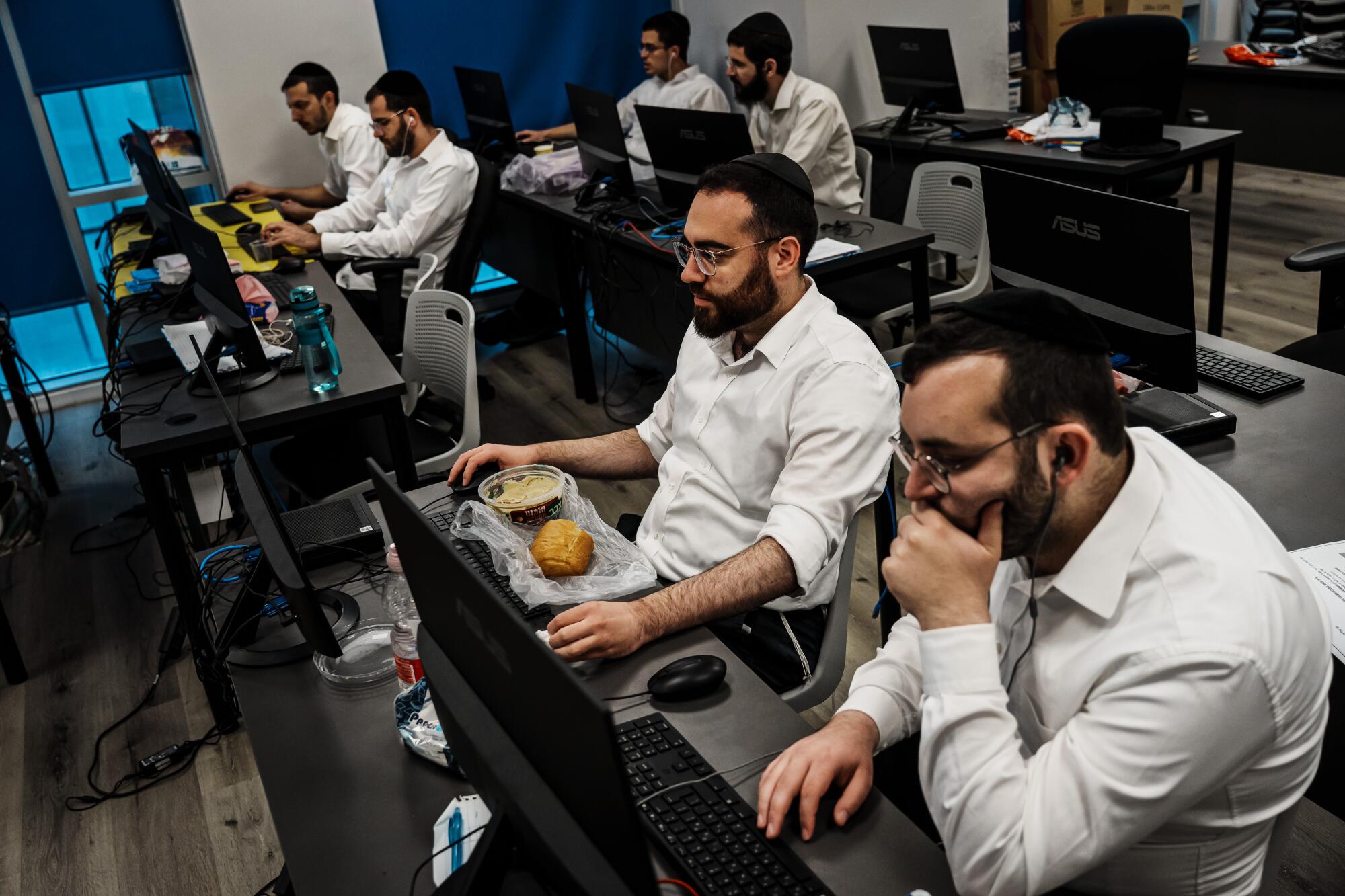 Adult students from Orthodox Jewish communities learn to code and program at JBH.