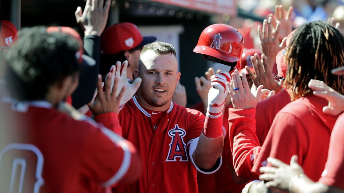 Angels' Mike Trout, center, is congratulated on his three-run home run against the Chicago Cubs in the third inning of a spring training game on Tuesday in Tempe, Ariz.