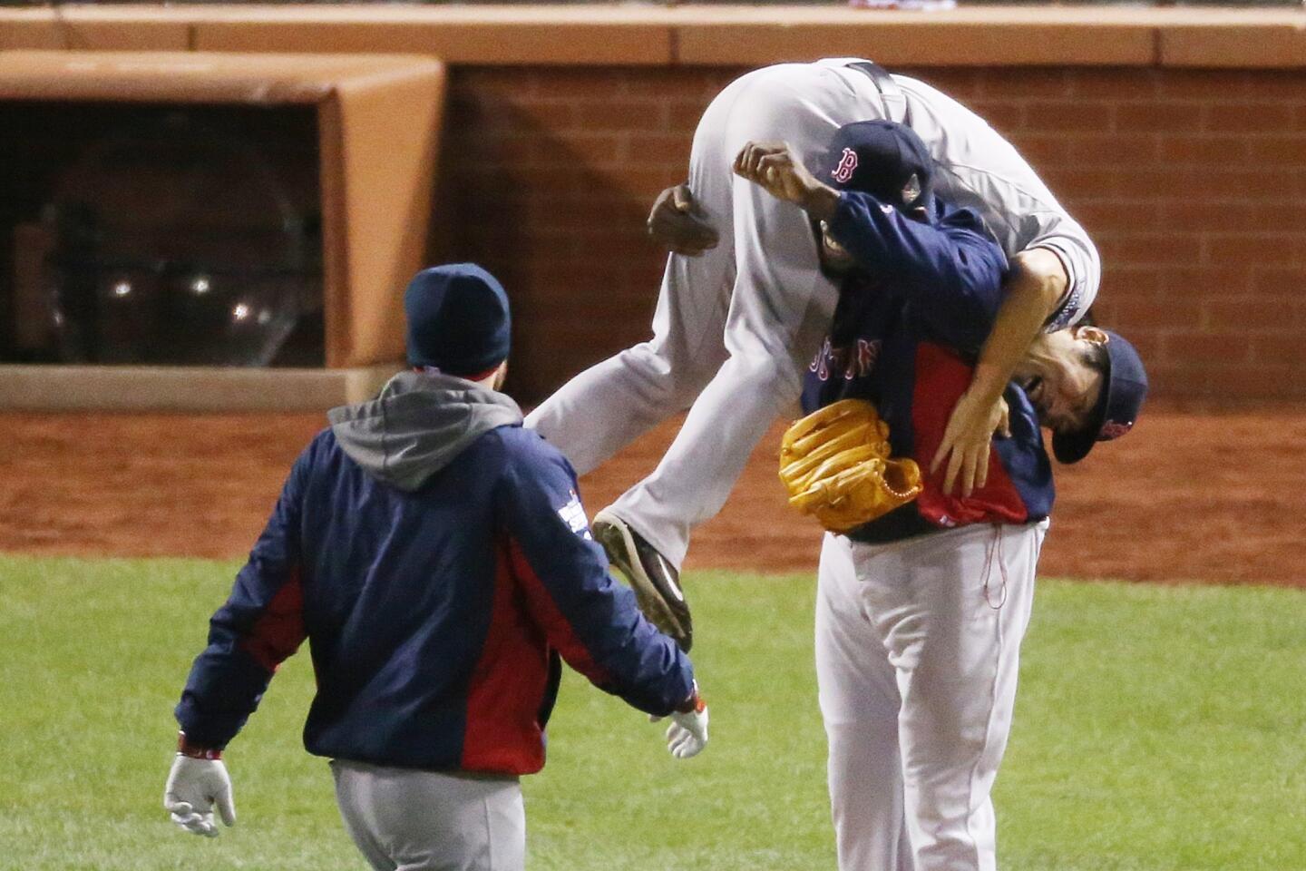 Red Sox first slugger David Ortiz lifts closer Koji Uehara after a 4-2 victory over the St. Louis Cardinals in Game 4 of the World Series on Sunday night at Busch Stadium.
