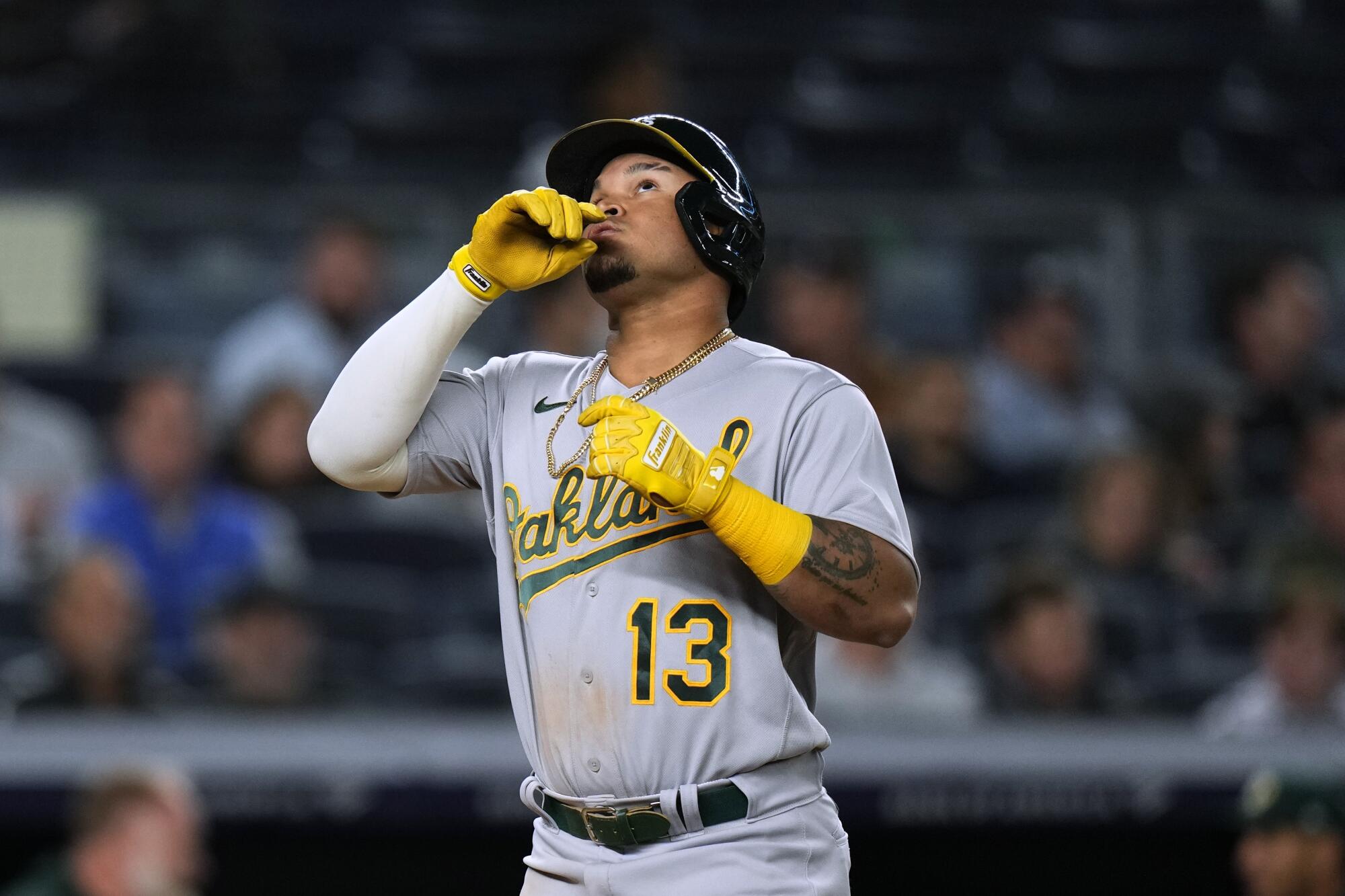 Oakland Athletics' Jordan Diaz gestures as he runs the bases after hitting a two-run home run.