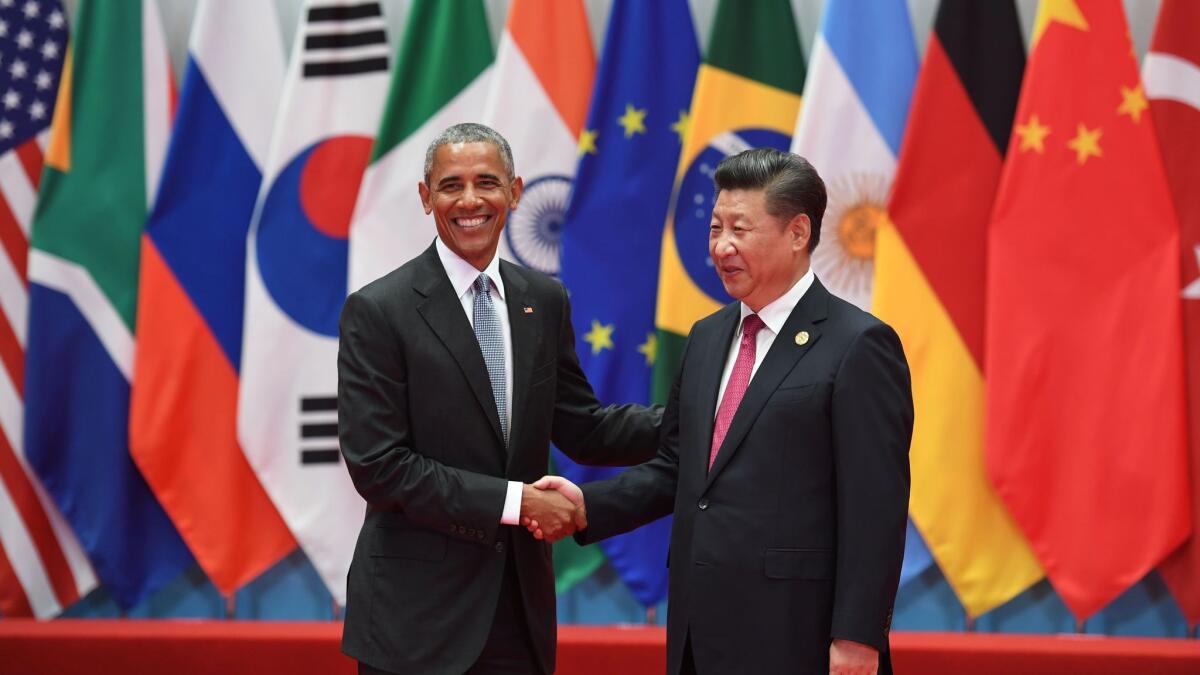 China's President Xi Jinping (R) shaking hands with US President Barack Obama in Hangzhou, China on September 4.