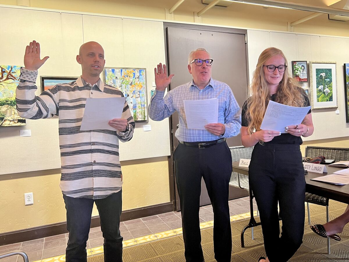 Brandon Lindley, Bill Podway and Hallie Swenson are sworn in as La Jolla Village Merchants Association board members June 8.