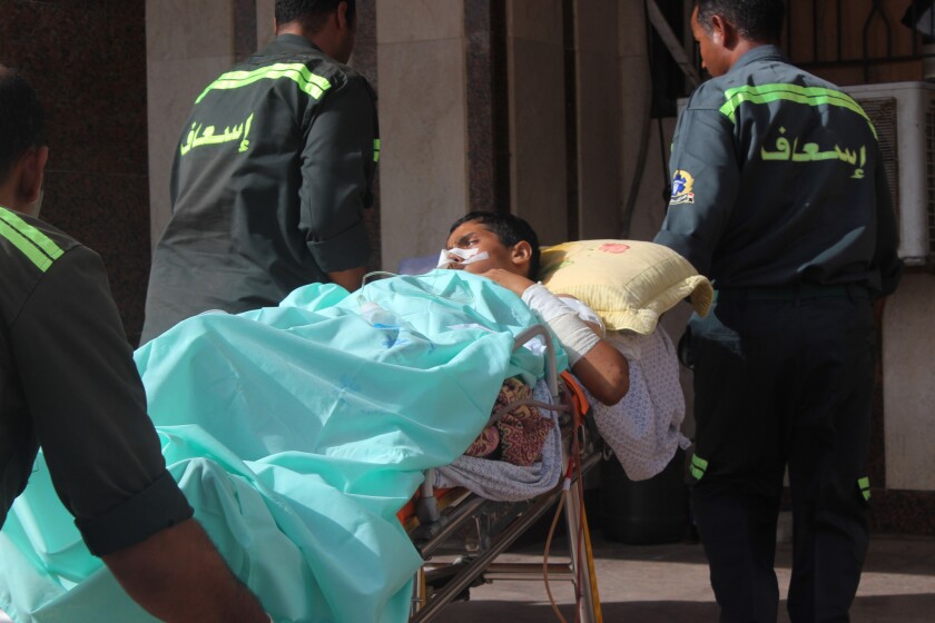Medics carry a 14-year-old Palestinian from the Gaza Strip into a hospital in El Arish on July 12.