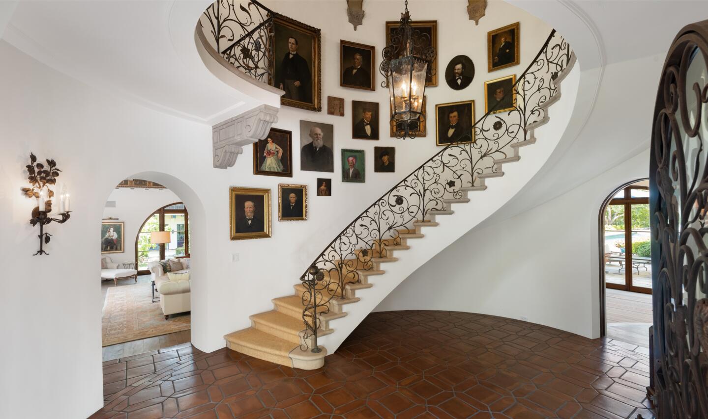 The foyer with winding staircase and tile floors.