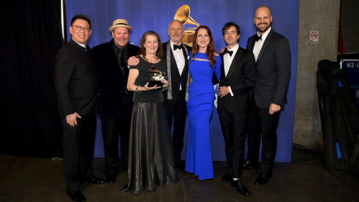The team behind opera recording winner "The (R)evolution of Steve Jobs," including composer Mason Bates, second from right, and Edward Parks, who played Jobs, far right, pose backstage at the Grammy Awards' pre-telecast ceremony Sunday at Microsoft Theater in L.A.
