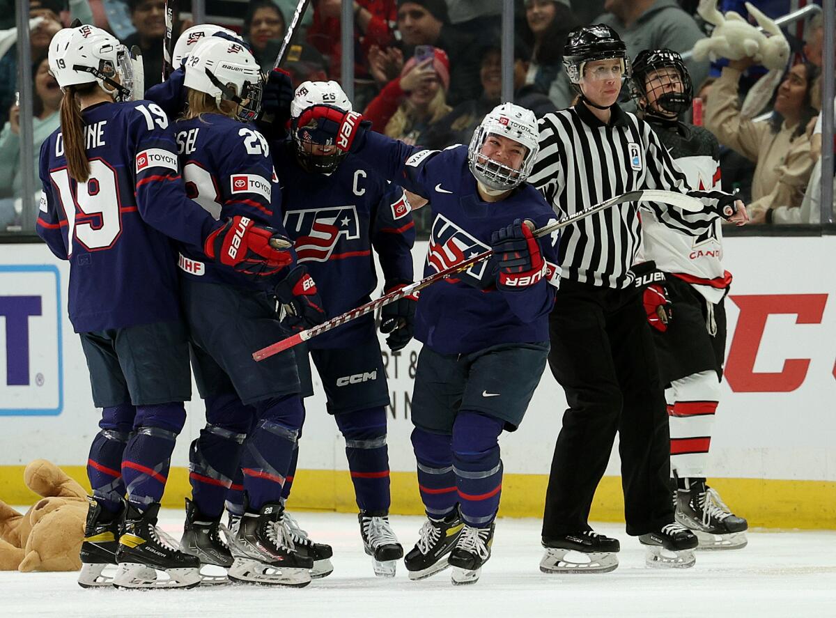 Cayla Barnes, right, celebrates with her teammates after scoring for the U.S. against Canada.