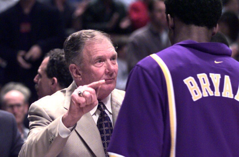 Bill Bertka, serving as Lakers interim coach, talks to then rookie guard Kobe Bryant before a game against the Clippers.