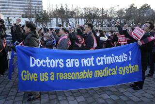 FILE - Doctors stage a rally against the government's medical policy near the presidential office in Seoul, South Korea, on Feb. 25, 2024. (AP Photo/Ahn Young-joon, File)