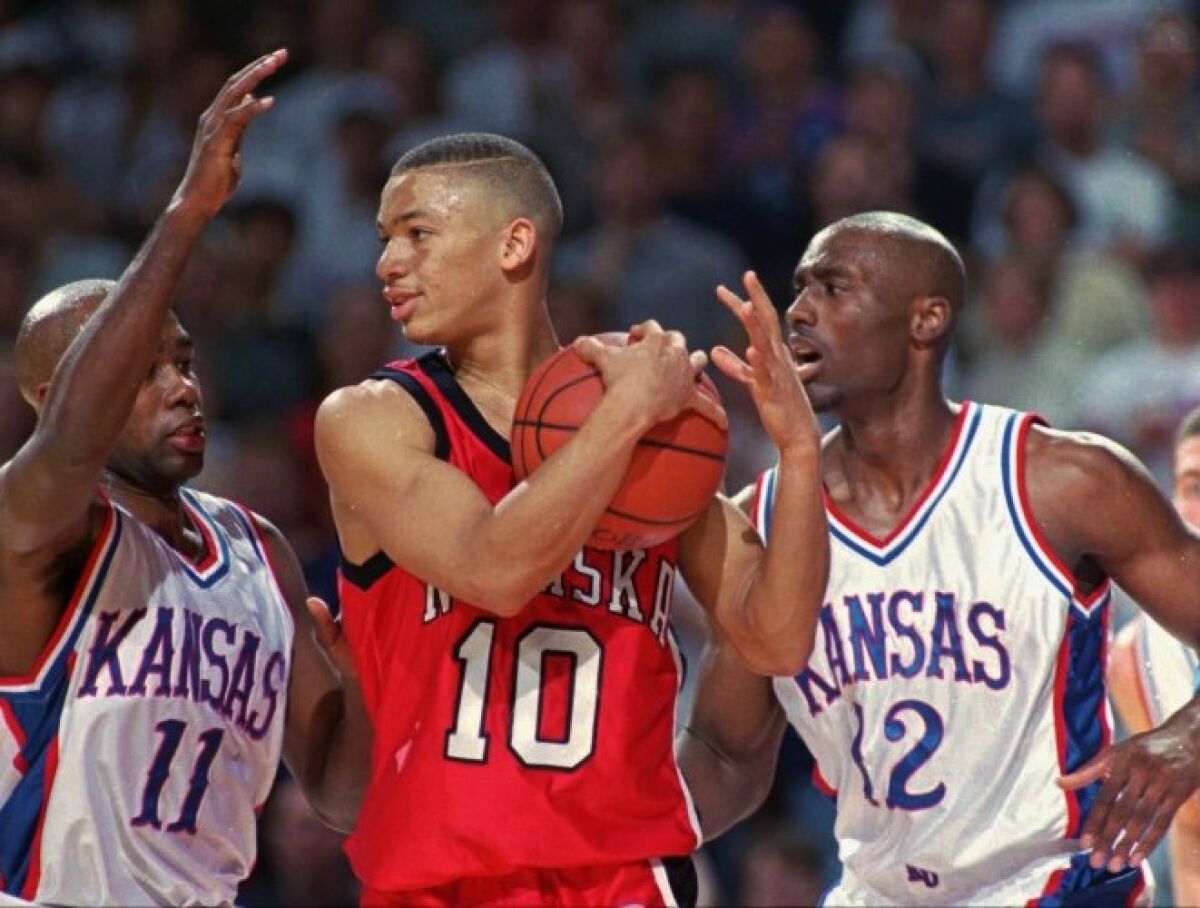 Nebraska's Tyronn Lue is sandwiched between Kansas' Jacque Vaughn (11) and Billy Thomas during a game Feb. 1, 1997.