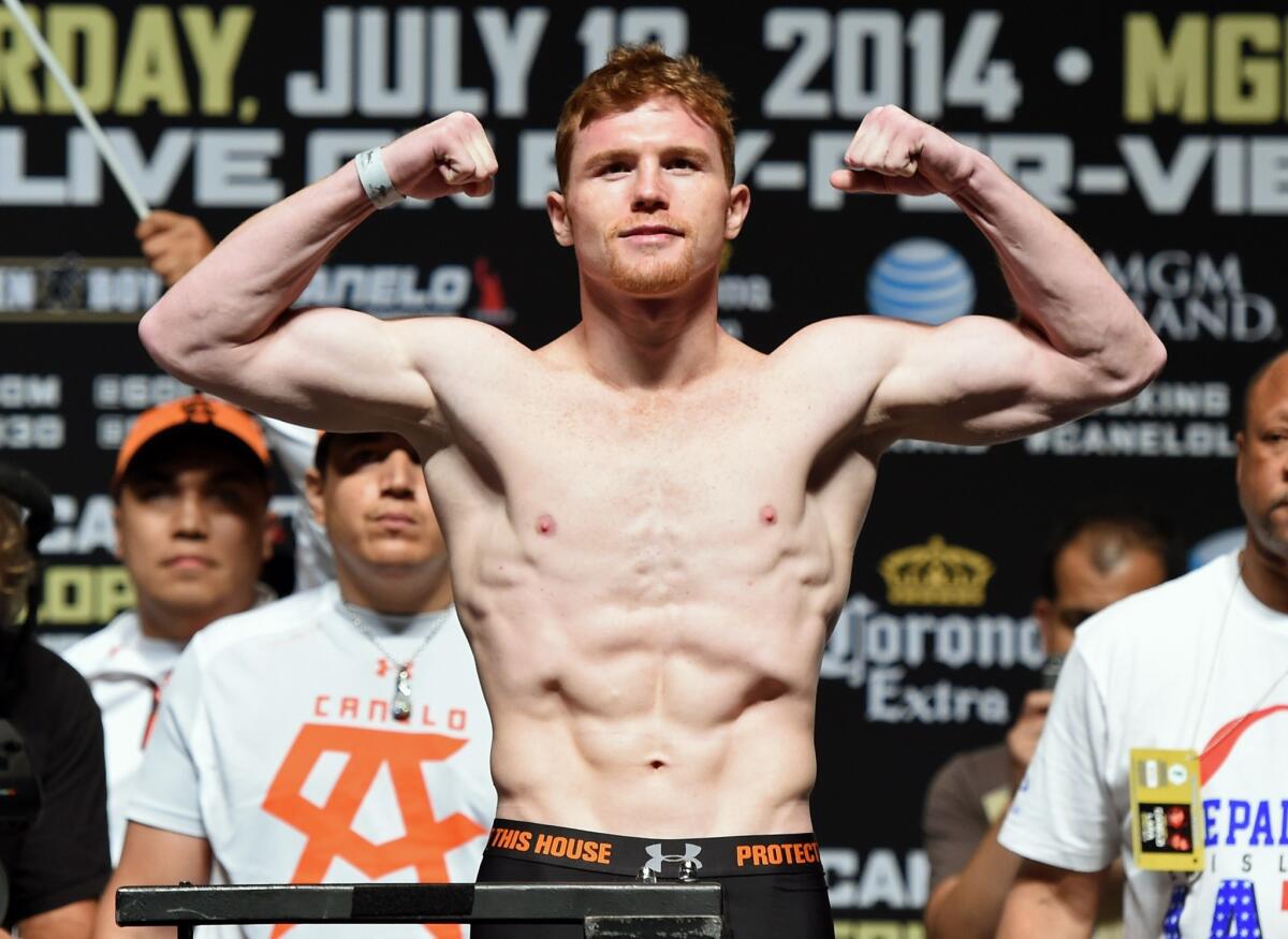 "Canelo" Alvarez poses on the scale during his official weigh-in for a bout against Erislandy Lara last July.