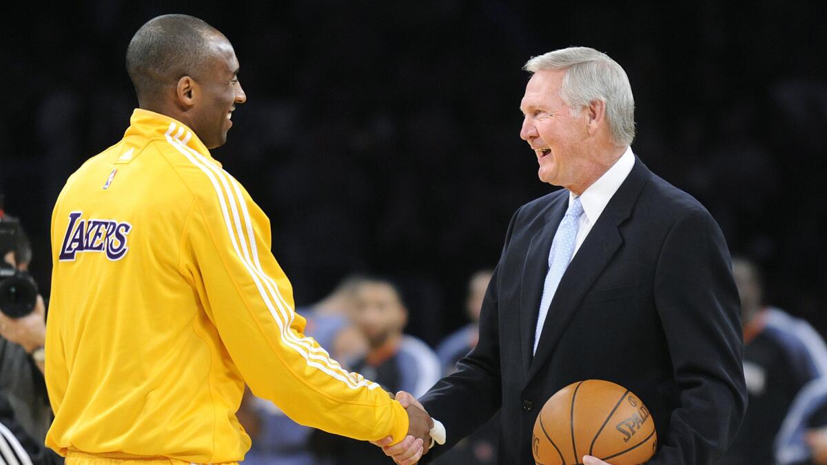 Kobe Bryant shakes hands with Jerry West in a 2010 ceremony to celebrate Bryant breaking the team record for most points.