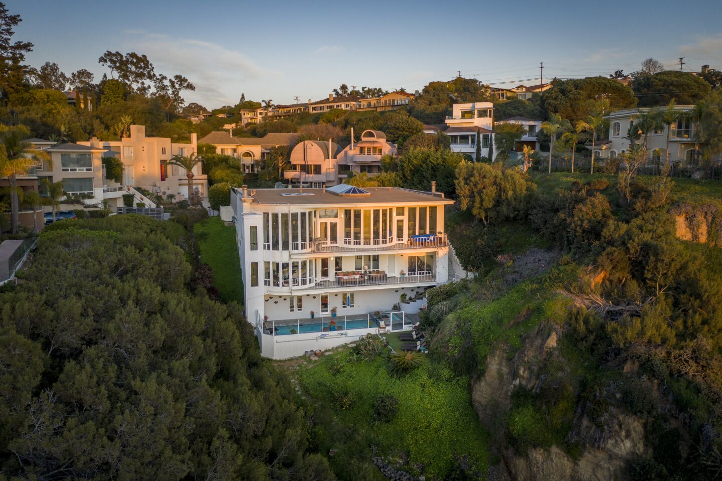 The three-story house sits on a canyon lot with unobstructed views.
