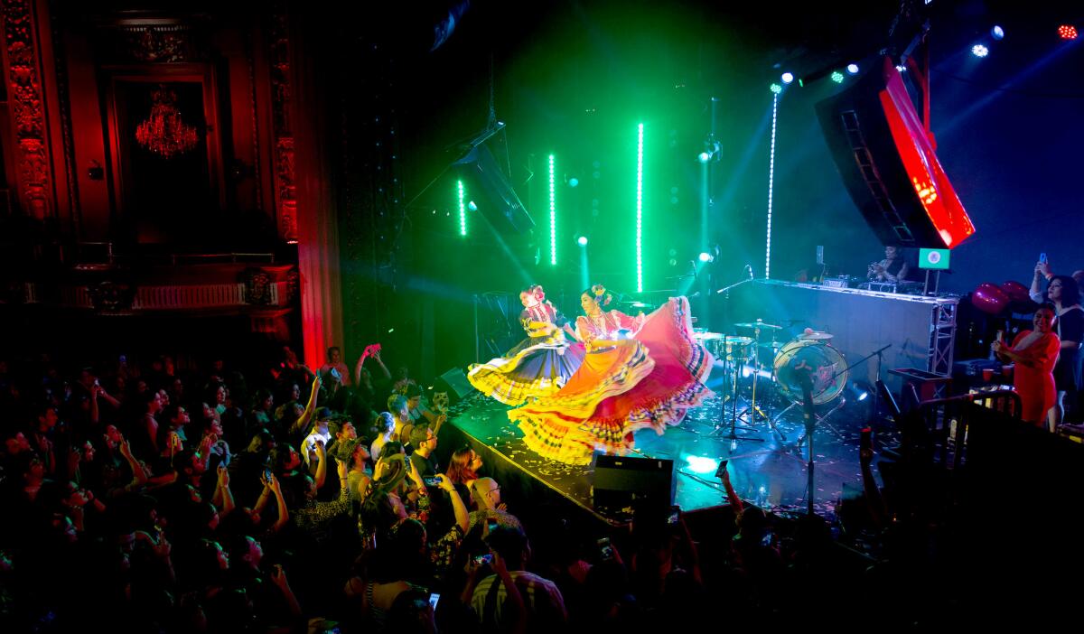 Dancers perform in front of an audience at a Cumbiaton event.