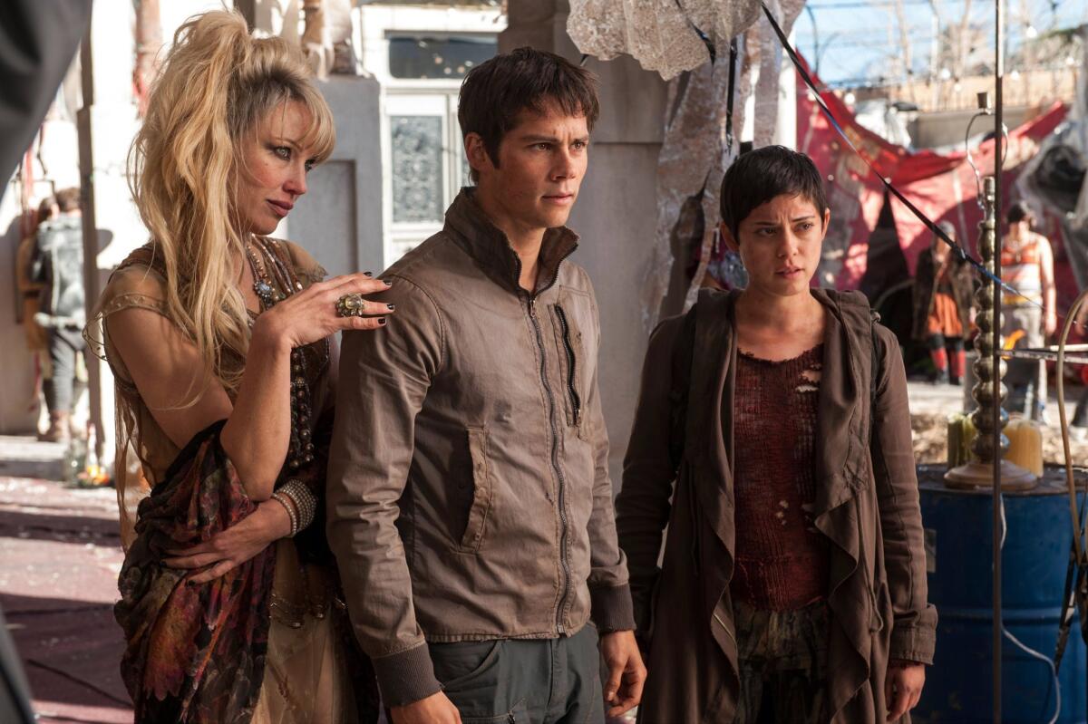 In this image released by 20th Century Fox, Jenny Gabrielle, from left, Dylan O’Brien and Rosa Salazar appear in a scene from "Maze Runner: The Scorch Trials." The film debuted with a studio-estimated $30.3 million at the domestic box office.