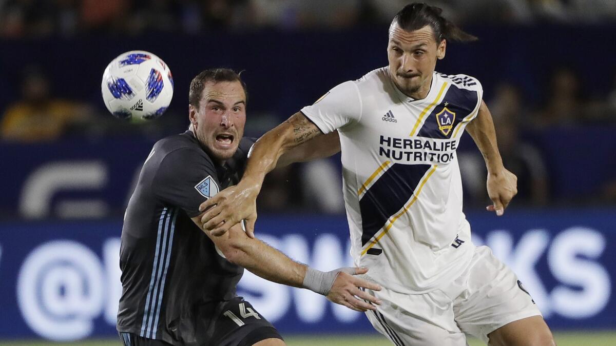 Galaxy's Zlatan Ibrahimovic, right, is defended by Minnesota's Brent Kallman on Aug. 11.