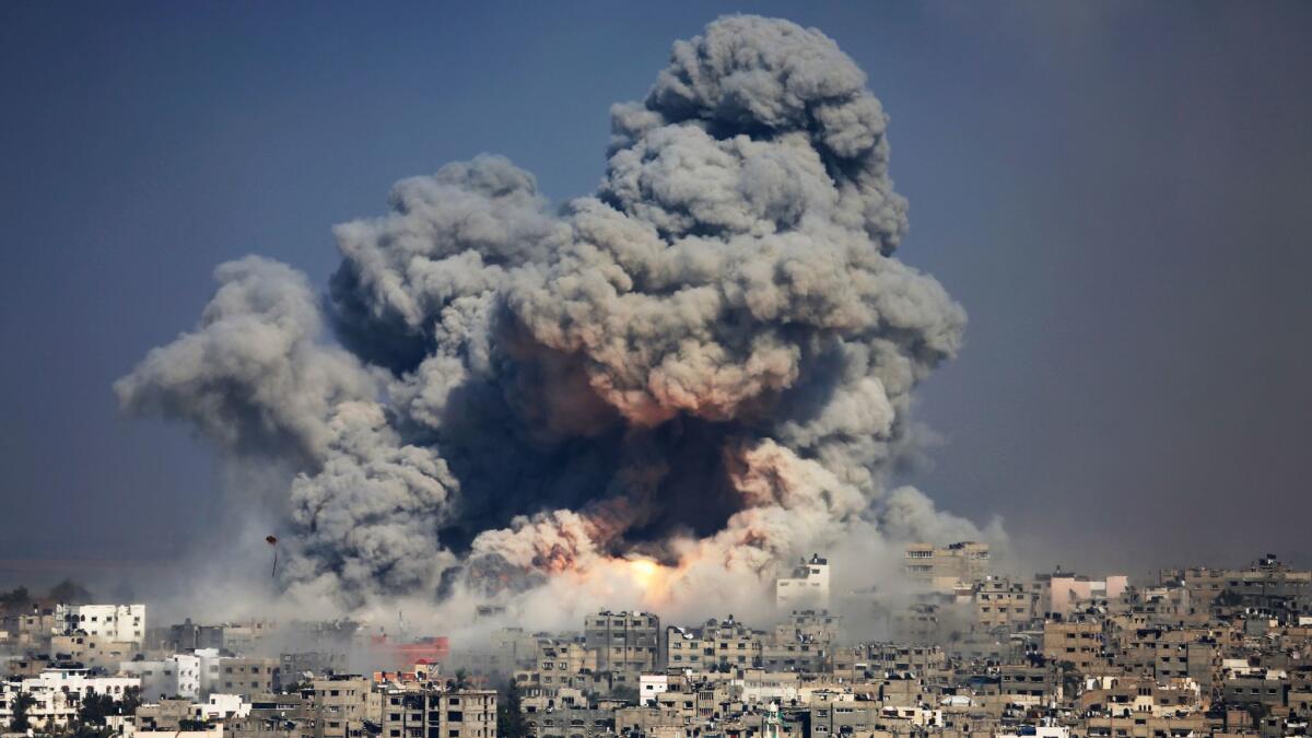 Smoke and flames from an Israeli strike rise over Gaza City in July 29, 2014.